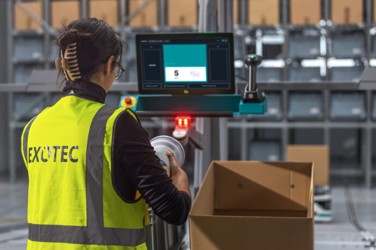 Warehouse operator at an automated, ergonomically designed workstation